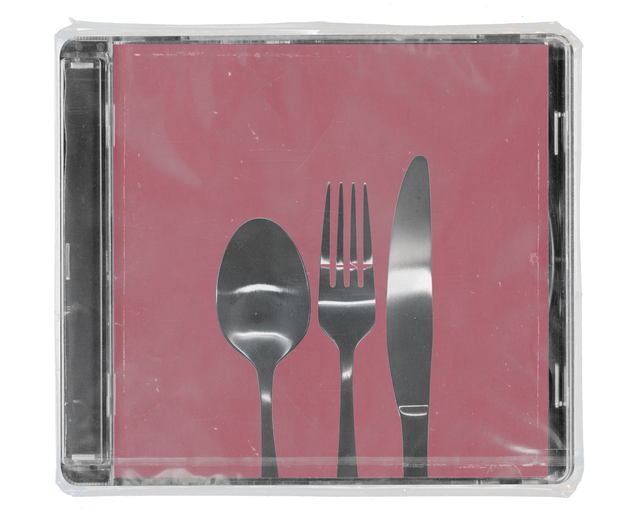 CD jewel case in clear shrink wrap. The cover shows a silver spoon, fork and knife standing upright against a dusty rose background.