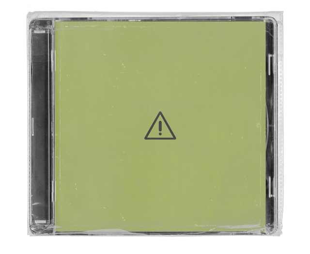 CD jewel case in clear shrink wrap. The cover is plain olive green with a single warning-triangle icon at its centre.