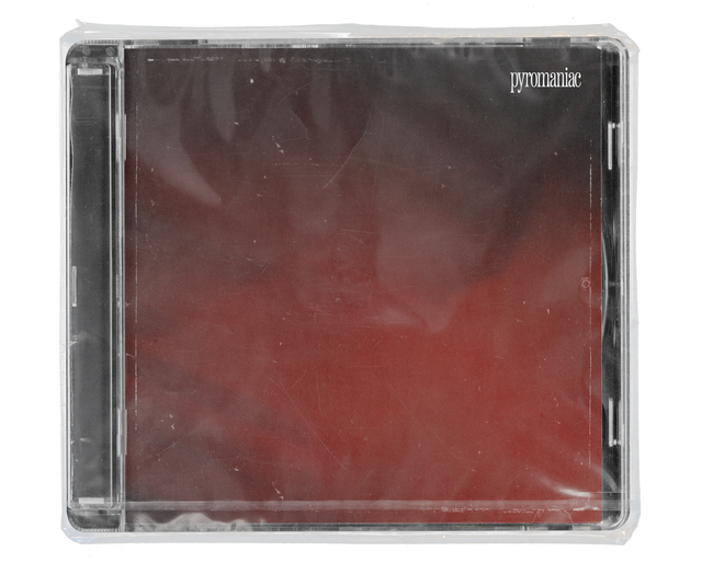CD jewel case in clear shrink wrap. The cover is a smoky dark-red gradient with the word 'pyromaniac' in small white serif type in the top right corner.