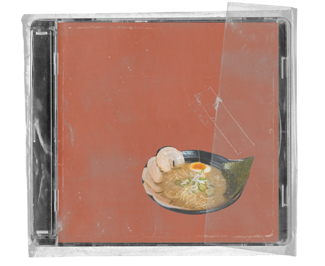 CD jewel case in clear shrink wrap. The cover is plain brick red with a cut-out photograph of a bowl of ramen with sliced pork, a soft-boiled egg and nori, and a strip of clear tape across the wrap.