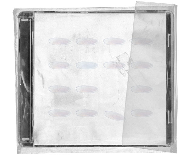 CD jewel case in clear shrink wrap. The cover is off-white and lightly stained, printed with neat rows of small pale oval shapes, with a strip of clear tape across the wrap.