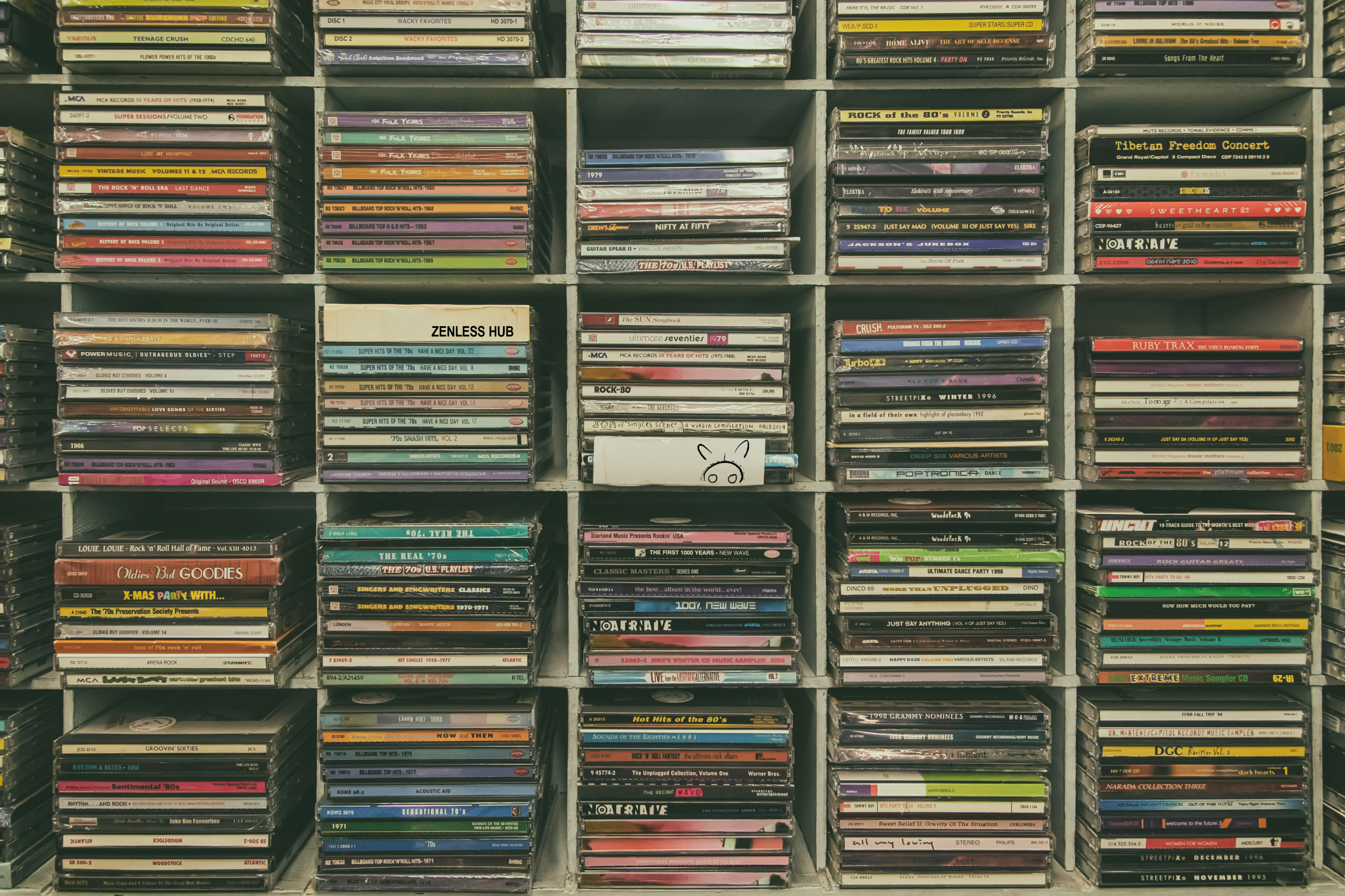 Shelf filled with various CDs and DVDs in a grid pattern