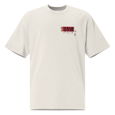 A faded bone oversized tee with an off centered graphic to the left side of the sweatshirt. The design features the word 'THYME' in a large, black font layered over a red rectangle accompanied by red text depicting "FIELD" underneath it.