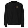 Front view of a solid-colored, longsleeve. A small graphic on the left chest features a large, high-contrast 'X' symbol next to a small, vertical block of text and code-like characters.