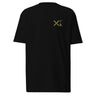 Front view of a solid-colored, shirt. A small graphic on the left chest features a large, high-contrast 'X' symbol next to a small, vertical block of text and code-like characters.