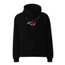Front view of a solid-colored oversized-hoodie. A graphic centered on the chest features a high-contrast, stylized illustration of a horned animal skull, with a compass rose symbol at its center and a dagger piercing through the top.