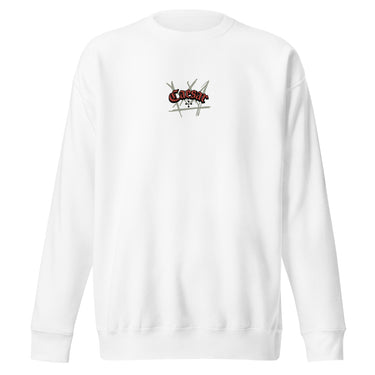 Front view of a solid-colored, sweatshirt. A small graphic is centered on the chest, featuring the word "Caesar" in a stylized script font, layered over a background of sketchy, crisscrossing lines.