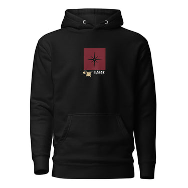 Front view of a solid-colored, hoodie. A small graphic is centered on the chest, featuring a solid vertical rectangle containing a four-pointed star. The word "LYRA" is next to it, and two small charm-like shapes hang from the bottom.