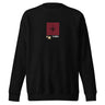 Front view of a solid-colored, sweatshirt. A small graphic is centered on the chest, featuring a solid vertical rectangle containing a four-pointed star. The word "LYRA" is next to it, and two small charm-like shapes hang from the bottom.