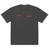 Front view of a solid-colored oversized-tee. Two separate small graphics are on the chest, featuring technical-style text such as "BELOBOG HEAVY INDUSTRIES" and "TECHNICAL EXPERT".