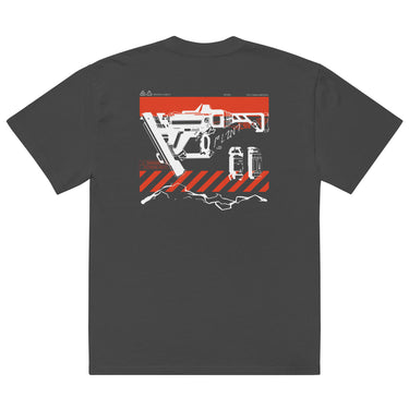 Back view of a solid-colored oversized-tee. A large graphic on the upper back features a detailed, high-contrast illustration of a futuristic nailgun. The design includes diagonal hazard stripes and schematic-style text and symbols emulating a blueprint.