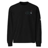 Front view of a solid-colored longsleeve. A small graphic on the left chest features a geometric, flower-like symbol made of fine lines, next to a vertical block of technical-style text.