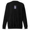 The front of a black sweatshirt. Centered on the chest is a small graphic featuring a stylized white symbol, resembling a chalice, set against a blue rectangular background.