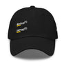 Black baseball cap, front view, showing embroidered black text 'MAGUS(1)' and 'ORPHIE(2)' stacked vertically with bold yellow underlines, visible distressed details on brim and panels.
