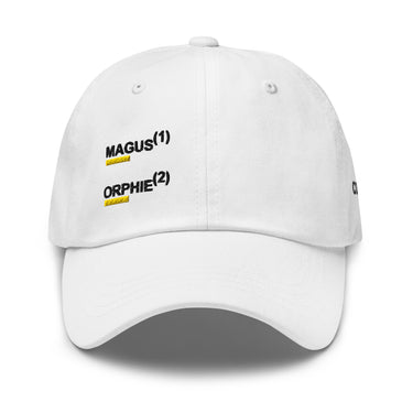 White baseball cap, front view, showing embroidered black text 'MAGUS(1)' and 'ORPHIE(2)' stacked vertically with bold yellow underlines, visible distressed details on brim and panels.