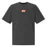 Faded black tee, front view, featuring a small centered orange rectangular logo with a stylized white 'M' inside.