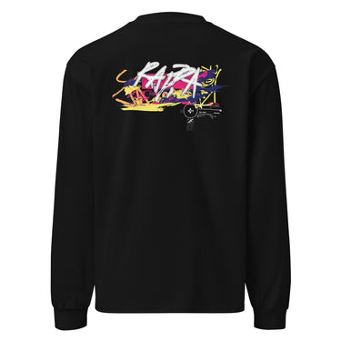 Back view of a solid-colored longsleeve. A large, horizontal graphic on the upper back features a stylized, graffiti-like word spelling “RAPPA” layered over a wide smear of high-contrast brush strokes imitating graffiti splatter. To the side are smaller, schematic graphics including a compass rose and blocks of text.