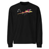 Front view of a solid-colored longsleeve. A large, dynamic graphic across the chest features a chaotic collage of high-contrast brush strokes, sharp angular forms, and silhouettes resembling swooping birds.