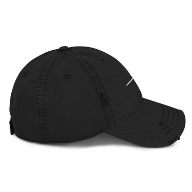A black distressed baseball cap shown from a front-left angle. The cap features a white embroidered "011" and a red starburst graphic, partially visible on the front. The cap has intentional rips and fraying on the brim and crown.