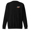 Front view of a solid-colored sweatshirt. A small, horizontal graphic on the left chest features the number "011" in a stylized font, layered over a starburst shape.