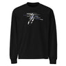 Front view of a solid-colored, longsleeve. The chest features a collage graphic with a textured, high-contrast vertical shape at its center. This is layered with multiple words in various fonts, such as "absolutes" and "burden," which are crossed by thin horizontal lines.