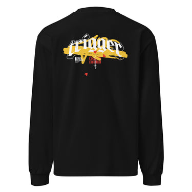 Back view of a solid-colored, longsleeve. A large, horizontal graphic on the upper back features the word "trigger" in a high-contrast, graffiti, streetwear-style font. This is layered over a wide brushstroke shape and several smaller text elements, including a barcode and a cross symbol.
