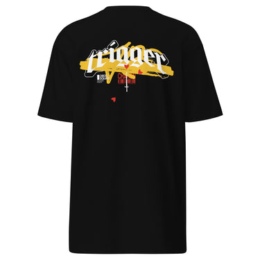 Back view of a solid-colored, shirt. A large, horizontal graphic on the upper back features the word "trigger" in a high-contrast, graffiti, streetwear-style font. This is layered over a wide brushstroke shape and several smaller text elements, including a barcode and a cross symbol.