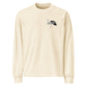 Front view of a solid-colored, longsleeve. A small graphic on the left chest features a fine-line illustration of a winged creature, layered with the word "premonition" in a high-contrast, distorted font.