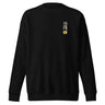 Front view of a sweatshirt. On the left chest is a small, vertical rectangular graphic containing three East Asian characters in a calligraphy style, positioned above a shape resembling an ancient coin.