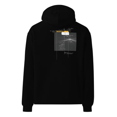 Back view of an oversized hoodie in black. Design shows a rectangular grayscale graphic centered on the upper back showing a lighthouse shining into darkness. Above the image is a yellow label reading “LIGHTKEEPER,” surrounded by thin white grid lines and handwritten script text for a technical, conceptual design aesthetic