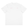 Front view of a box tee in white, flat. Design features small text printed across the upper chest: the word ‘genesis’ on the left side, preceded by a circular symbol, and the word ‘ego’ on the right side preceded by a music note.