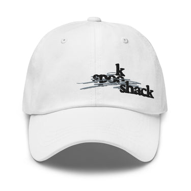 Front view of an baseball cap in white. It features an embroidered logo with the words "spook shack" in a stylized, stacked font, layered over abstract horizontal brush strokes.