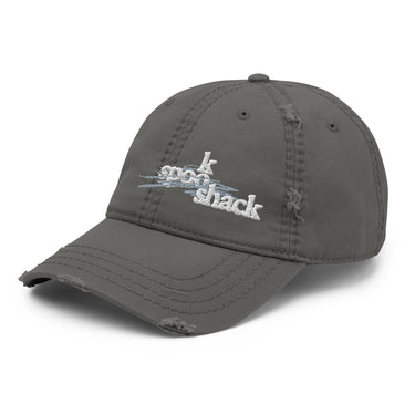 3/4 view of an distressed hat in white. The embroidered logo "spook shack" is shown on the front panel, designed with a stylized font and layered over abstract horizontal brush strokes.