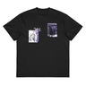 Front view of a box tee in black, flat. The chest features two separate collage-style graphics. One is a vertical rectangle containing a high-contrast illustration of a thorny bush. The other graphic features a line drawing of a character's head and hair, with several star shapes and a solid rectangular background.
