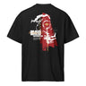 Back view of a Box Tee in Black. a large back graphic centered on a jagged, torn-map style emblem in white with a glowing star burst at its center, layered over angled orange-red geometric panels resembling sail or flag fragments, alongside a bold two-line wordmark, a short block of descriptive text, and a smaller diagonal wordmark near the hem
