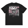 Back view of a box tee in black. A large rectangular back graphic layers an ornate hall interior in high-contrast greyscale beneath oversized roman numerals 'XXXVII' and a serif 'IN SILENTIO' wordmark. Dusty pink text bars carry a short poem down the left edge, cut through by thorned starburst linework in the same pink.
