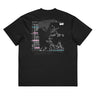 Back view of a box tee in Black. A large collaged graphic fills the back: a ruled record card labelled "ONI BLOOD", "NAME" and "POSITION AND RANK" in small white capitals, its name line filled in with pink Japanese characters over a faint column of typewritten Latin plant names struck through with pink and teal highlighter bars. Beside it, an expressive white line drawing of a figure with a long bladed polearm sits over halftone shading and translucent dark panels.