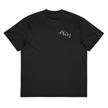 Front view of a box tee in black. A small left-chest graphic reads 'SOLA EGO' in a high-contrast serif, split across two lines, with two four-pointed star accents in dusty pink flanking the type.