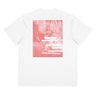 Back view of a box tee in white. A large coral pink poster panel fills the upper back, printed with a stylized winged figure in soft tonal linework set against a bank of clouds. Horizontal white bars redact most of the text, leaving the words "she, who silences the ether" legible between them, with faint handwritten script and a small circular seal layered underneath. An expressive, editorial, graphic-forward composition.