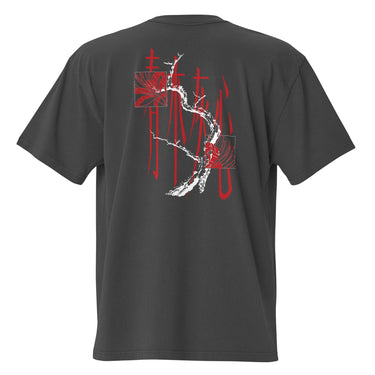 Back view of a oversized tee in faded black. Four large vermillion brushstroke characters reading "春木灰心" run vertically down the center, layered with a stark white-and-red painterly tree branch winding through them. Two crimson rectangles bracket smaller ink motifs in the upper-left and lower-right, giving the composition an expressive, calligraphic, graphic-forward feel.

