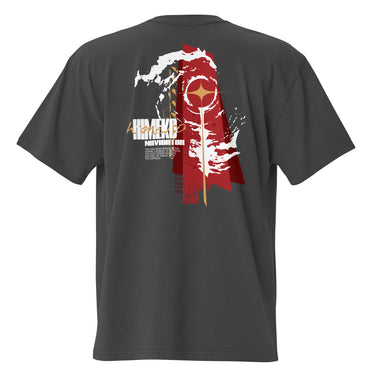 Back view of a Oversized Tee in Faded Black. a large back graphic centered on a jagged, torn-map style emblem in white with a glowing star burst at its center, layered over angled orange-red geometric panels resembling sail or flag fragments, alongside a bold two-line wordmark, a short block of descriptive text, and a smaller diagonal wordmark near the hem