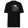 Back view of an t-shirt in black. Design shows a rectangular grayscale graphic centered on the upper back showing a lighthouse shining into darkness. Above the image is a yellow label reading “LIGHTKEEPER,” surrounded by thin white grid lines and handwritten script text for a technical, conceptual design aesthetic
