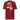 Back view of a T-Shirt in Brick Red. a large back graphic centered on a jagged, torn-map style emblem in white with a glowing star burst at its center, layered over angled orange-red geometric panels resembling sail or flag fragments, alongside a bold two-line wordmark, a short block of descriptive text, and a smaller diagonal wordmark near the hem