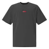 Front view of an oversized tee in black. Design is a small, embroidered red patch on the left chest featuring the white line art of an Astral Express ticket from Honkai: Star Rail.