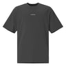 Front view of an oversized tee in black. Minimal design featuring a small white lowercase word “constance” centered across the upper chest. The typography is clean and modern, standing out subtly against the solid black fabric.