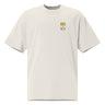 Front view of an oversized tee in faded bone. Design features a small graphic on the left chest. The graphic has the phrase "Pillar of Stone" stacked word on word in all caps. The word "Pillar" is highlighted in yellow.