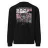 Back view of a longsleeve in black. A large rectangular back graphic layers an ornate hall interior in high-contrast greyscale beneath oversized roman numerals 'XXXVII' and a serif 'IN SILENTIO' wordmark. Dusty pink text bars carry a short poem down the left edge, cut through by thorned starburst linework in the same pink.