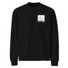 Front view of a longsleeve in black. A small halftoned panel sits on the left chest: a bare, leafless tree standing over dark undergrowth, printed with a woven fabric texture and rough torn edges. Below it the words "pas seul" are set in a fine serif, the letters scattered and stepping down to the right.