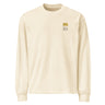 Front view of an longsleeve in ecru. Design features a small graphic on the left chest. The graphic has the phrase "Pillar of Stone" stacked word on word in all caps. The word "Pillar" is highlighted in yellow.