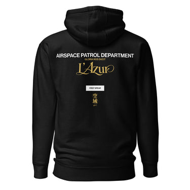 Back view of a hoodie in Black. A stacked graphic fills the upper back: "AIRSPACE PATROL DEPARTMENT" in heavy white capitals, "GLORIA NOS DUCIT" in smaller gold capitals beneath it, then "L'Azur" in a large gold script with a long trailing flourish. Below sit a small white box lettered "FIRST SPEAR" in black, a weathered gold seal stamp carrying two characters, and "gen 5" in gold.